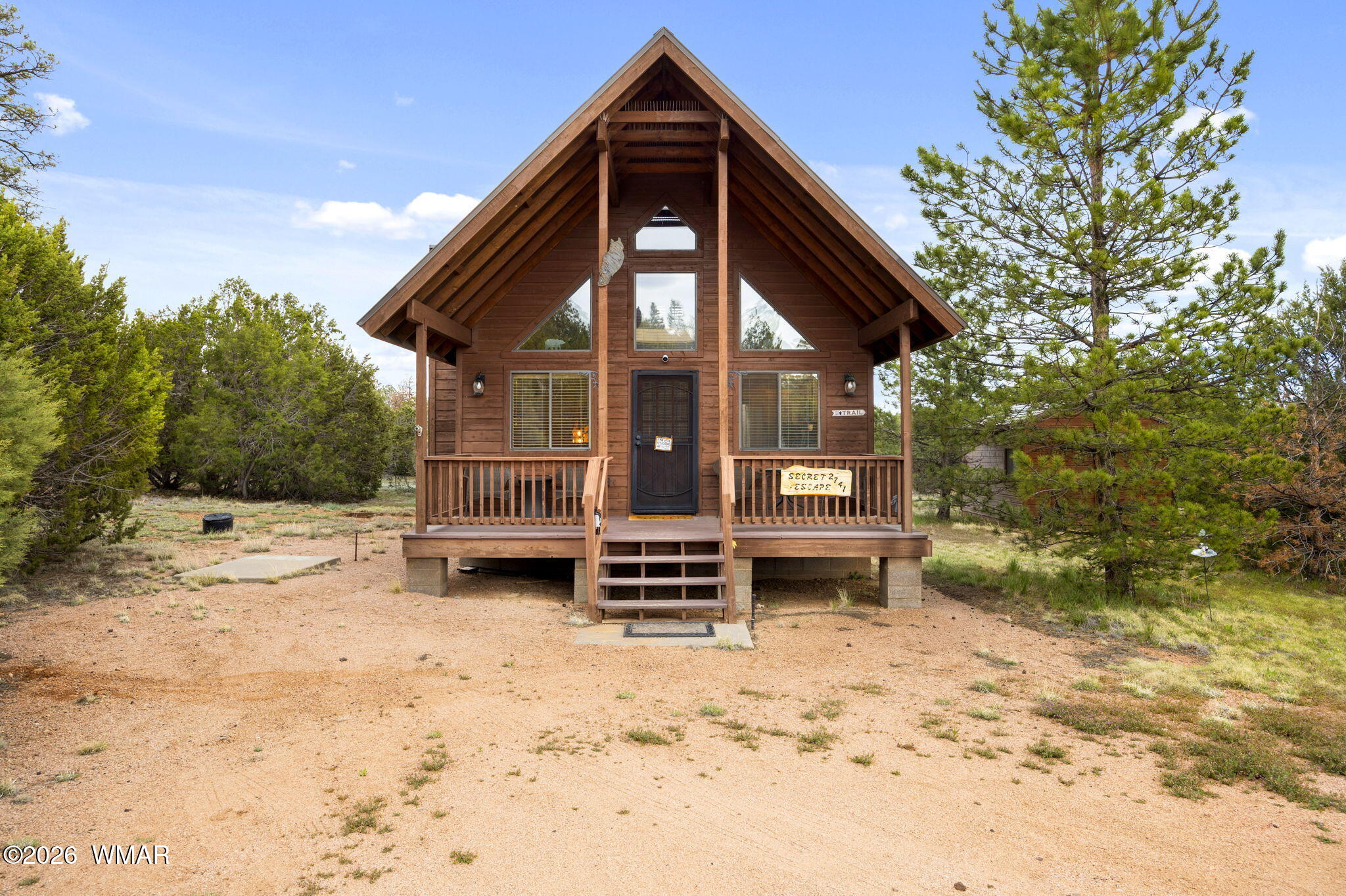 2741 Elk Trail Road Overgaard, AZ 85933 - Photo 3 of 68 a front view of a house with a yard