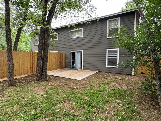 a view of a house with a yard and tree