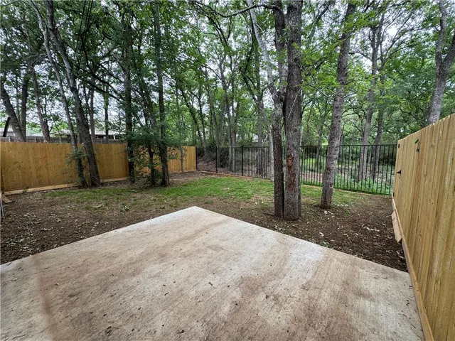a view of a park with large trees
