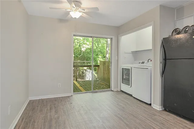 a view of a kitchen with a sink a refrigerator and wooden floor