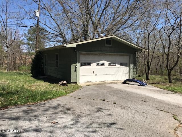 1679 Hillendale Road Crossville, TN 38572 - Photo 20 of 52 a view of a house with a yard and garage