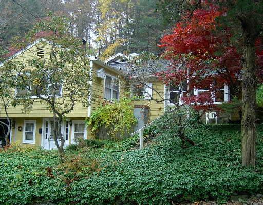 846 Danbury Road Wilton, CT 06897 - Photo 1 of 1 a front view of a house with plants and trees