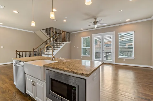 an open kitchen with a sink and chandelier