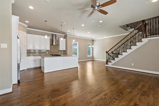 a view of kitchen with wooden floor and electronic appliances