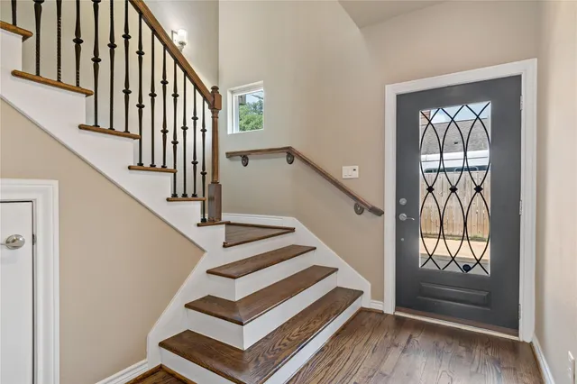 a view of entryway and hall with wooden floor