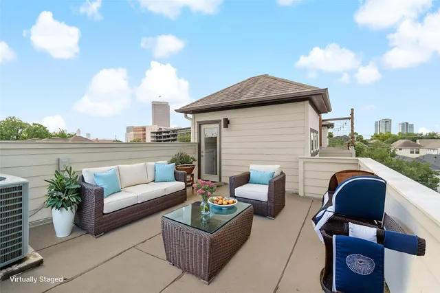 a terrace with outdoor seating and city view