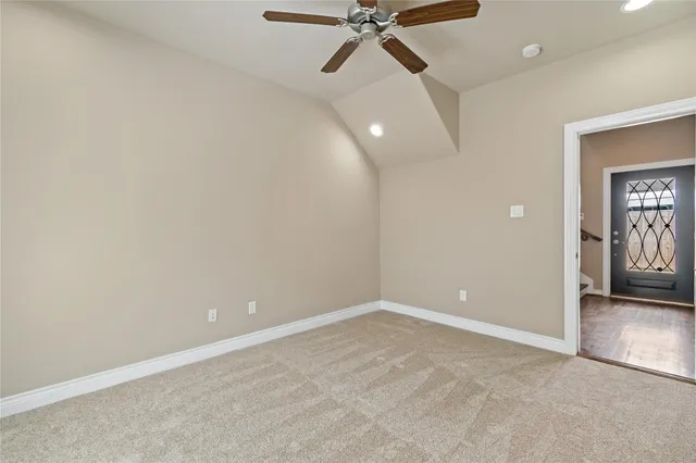 an empty room with closet and fan