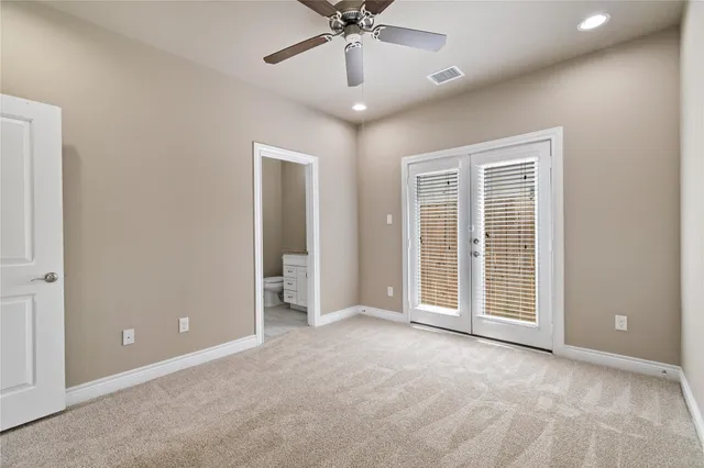 a view of a livingroom with a ceiling fan and window