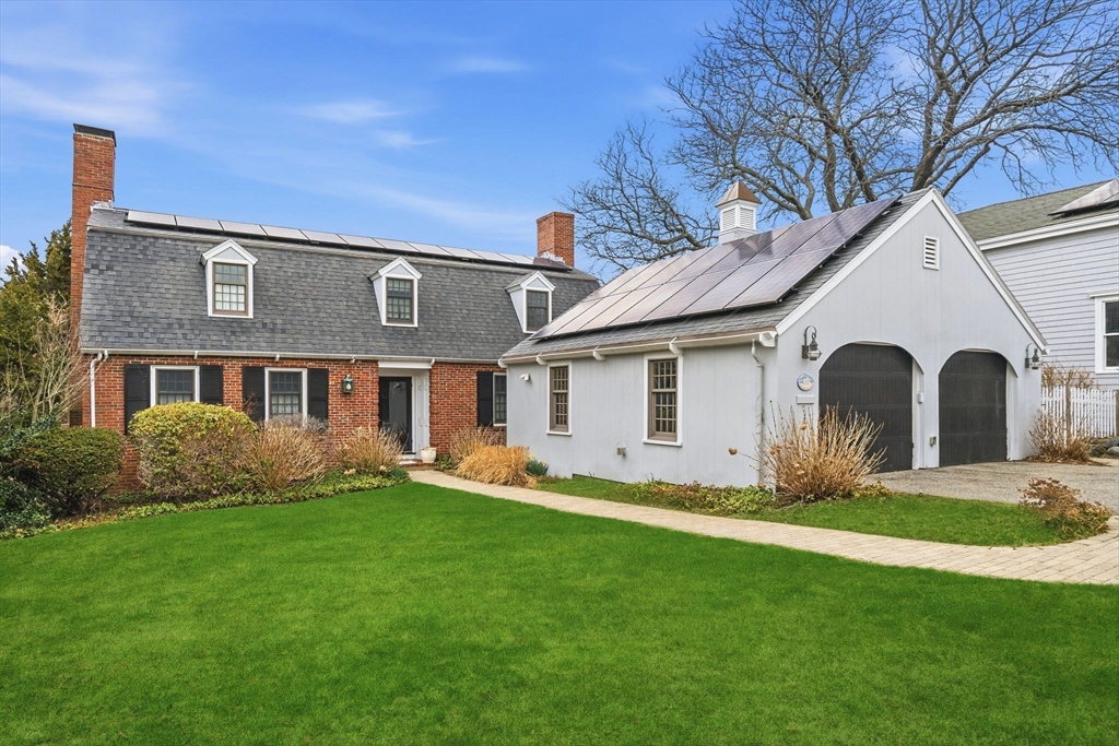 a front view of house with yard and green space