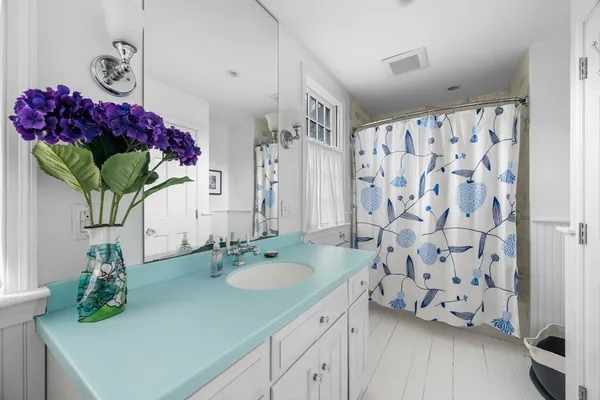 a bathroom with a sink vanity and a mirror