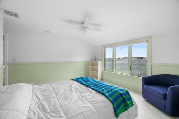 a bedroom with a large bed and a large window