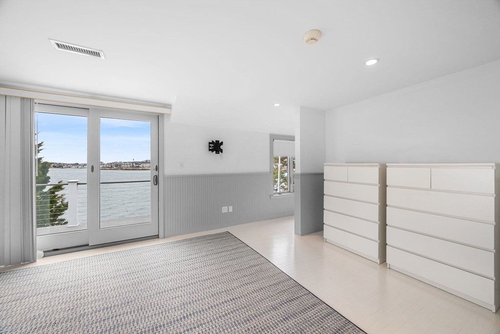 31 Lincoln House Point Swampscott, MA 01907 - Photo 22 of 33 a view of an empty room with wooden floor and windows