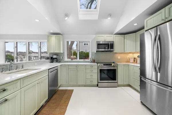 a kitchen with a refrigerator sink and microwave