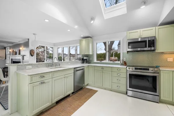 a kitchen with stainless steel appliances granite countertop a stove sink and microwave