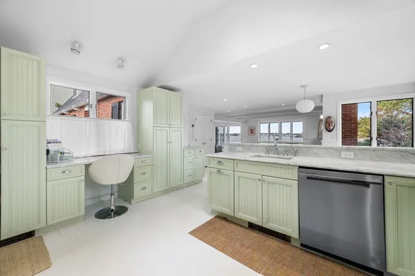 a bathroom with a granite countertop sink a toilet and a mirror
