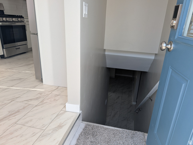 2880 Merton Way Magna, UT 84044 - Photo 10 of 30 Entryway featuring a blue door with a smart lock, leading to a staircase with a handrail