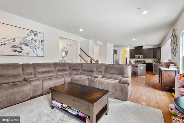 a living room with furniture and kitchen view