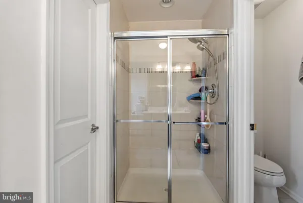 a bathroom with a glass shower door