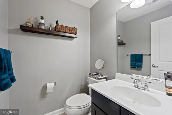 a bathroom with a toilet a sink and mirror