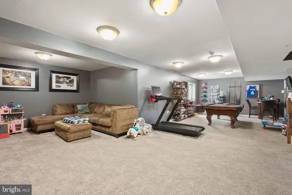 a living room with furniture and gym equipment