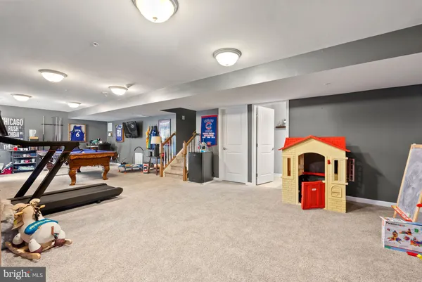 a living room with furniture and gym equipment