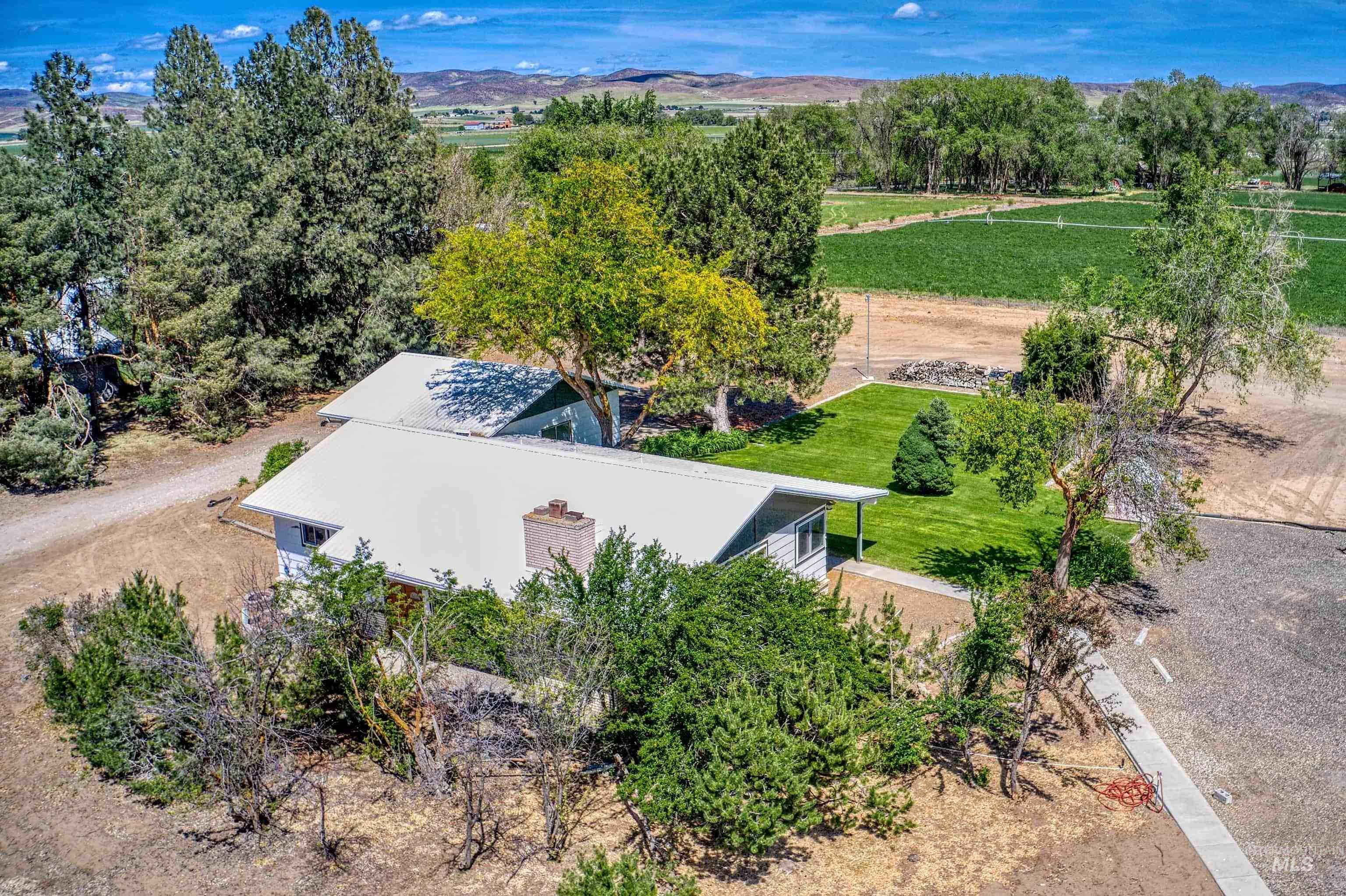 748 Pringle Road Weiser, ID 83672 - Photo 41 of 47 Rural property featuring a single-story residence with a metal roof and a brick chimney