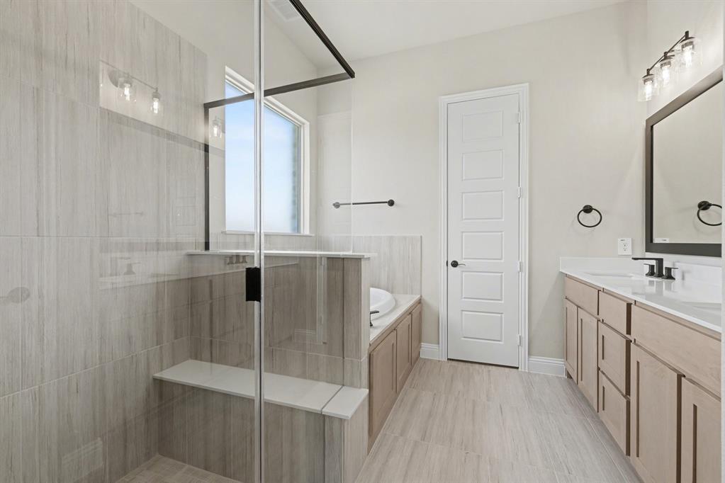 7041 Champion Road Midlothian, TX 76065 - Photo 16 of 30 a bathroom with a double vanity sink a mirror and a shower