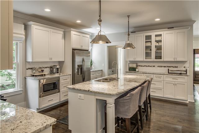 3518 Murphy Road Nashville, TN 37205 - Photo 9 of 20 a kitchen with a stove a sink a center island and cabinets