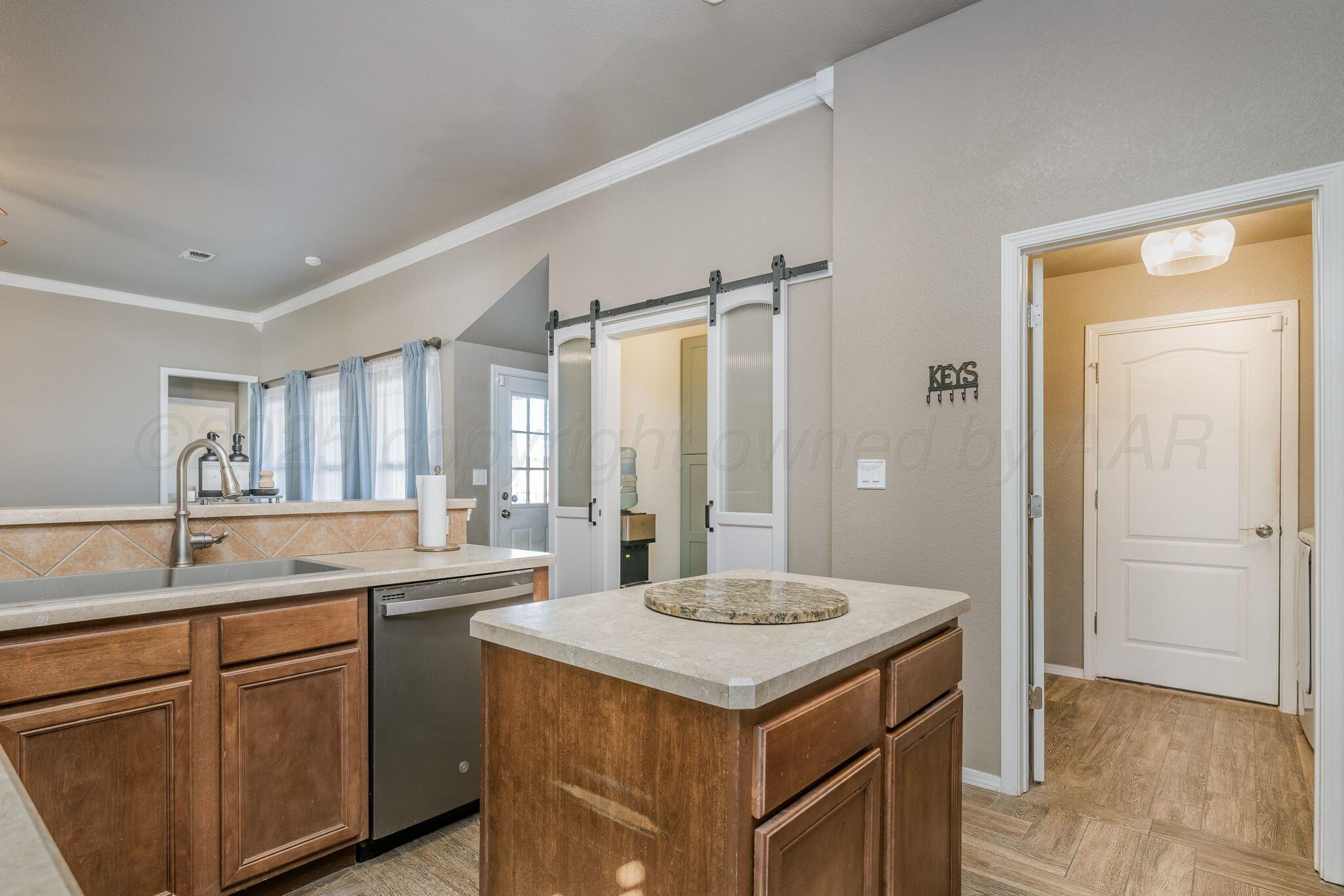 1404 Southwest 61st Avenue Amarillo, TX 79118 - Photo 11 of 30 a kitchen with a sink and cabinets