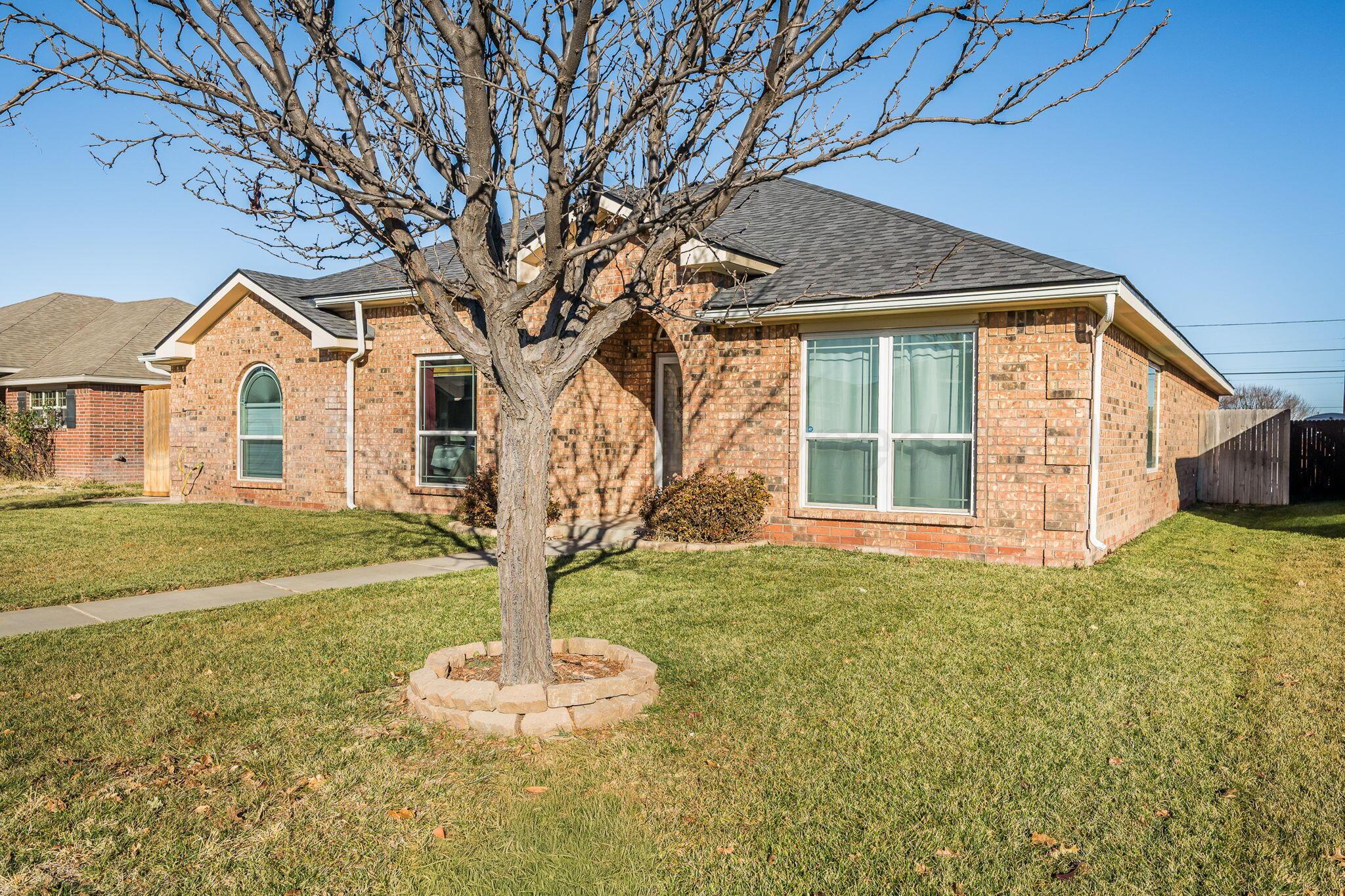 1404 Southwest 61st Avenue Amarillo, TX 79118 - Photo 2 of 30 a front view of a house with a yard