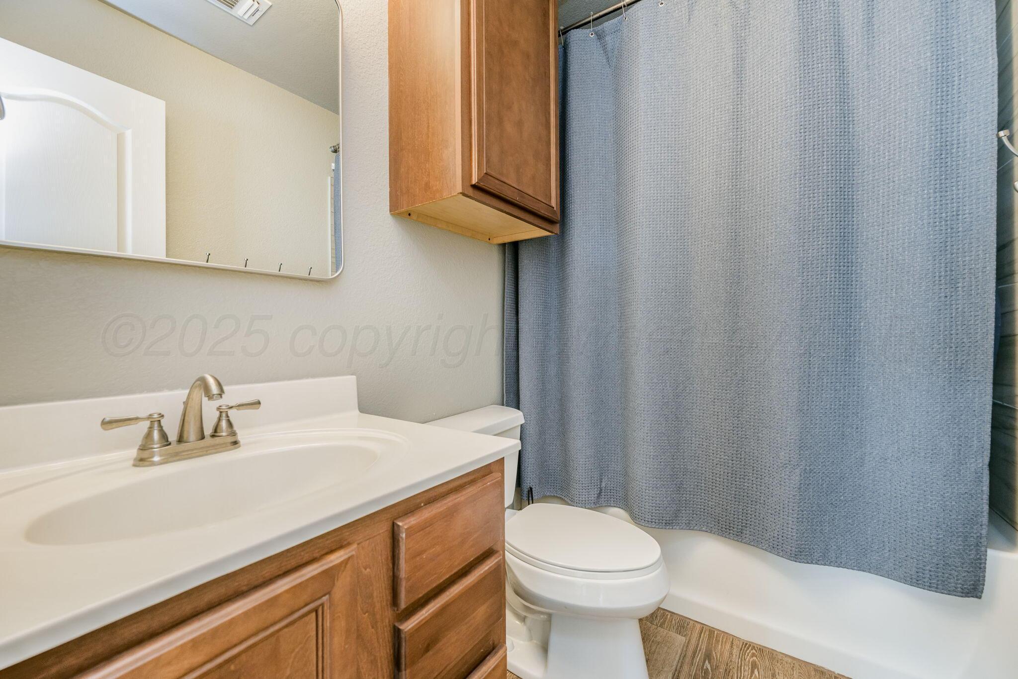 1404 Southwest 61st Avenue Amarillo, TX 79118 - Photo 23 of 30 a bathroom with a sink a toilet and vanity