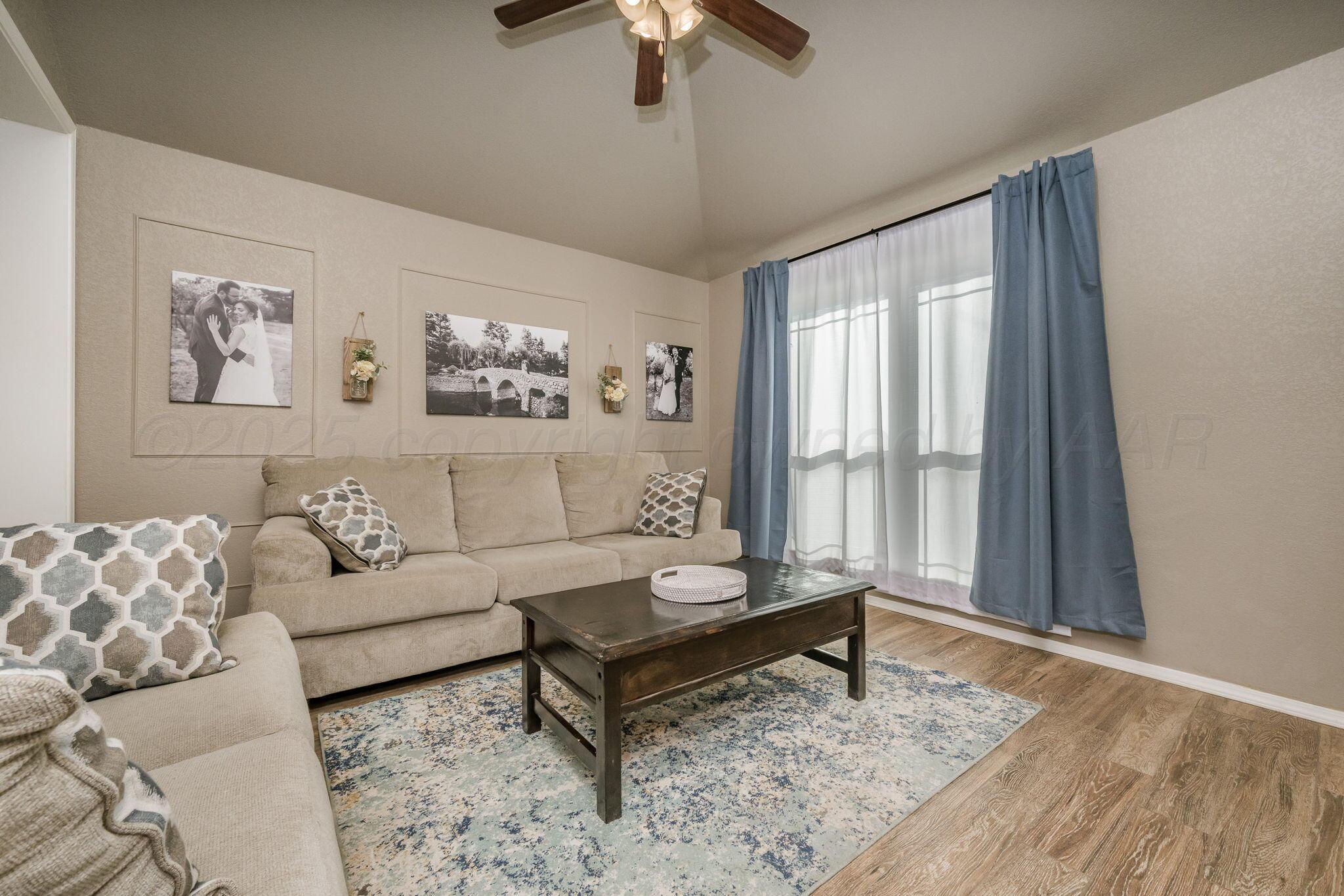 1404 Southwest 61st Avenue Amarillo, TX 79118 - Photo 4 of 30 a living room with furniture and a large window