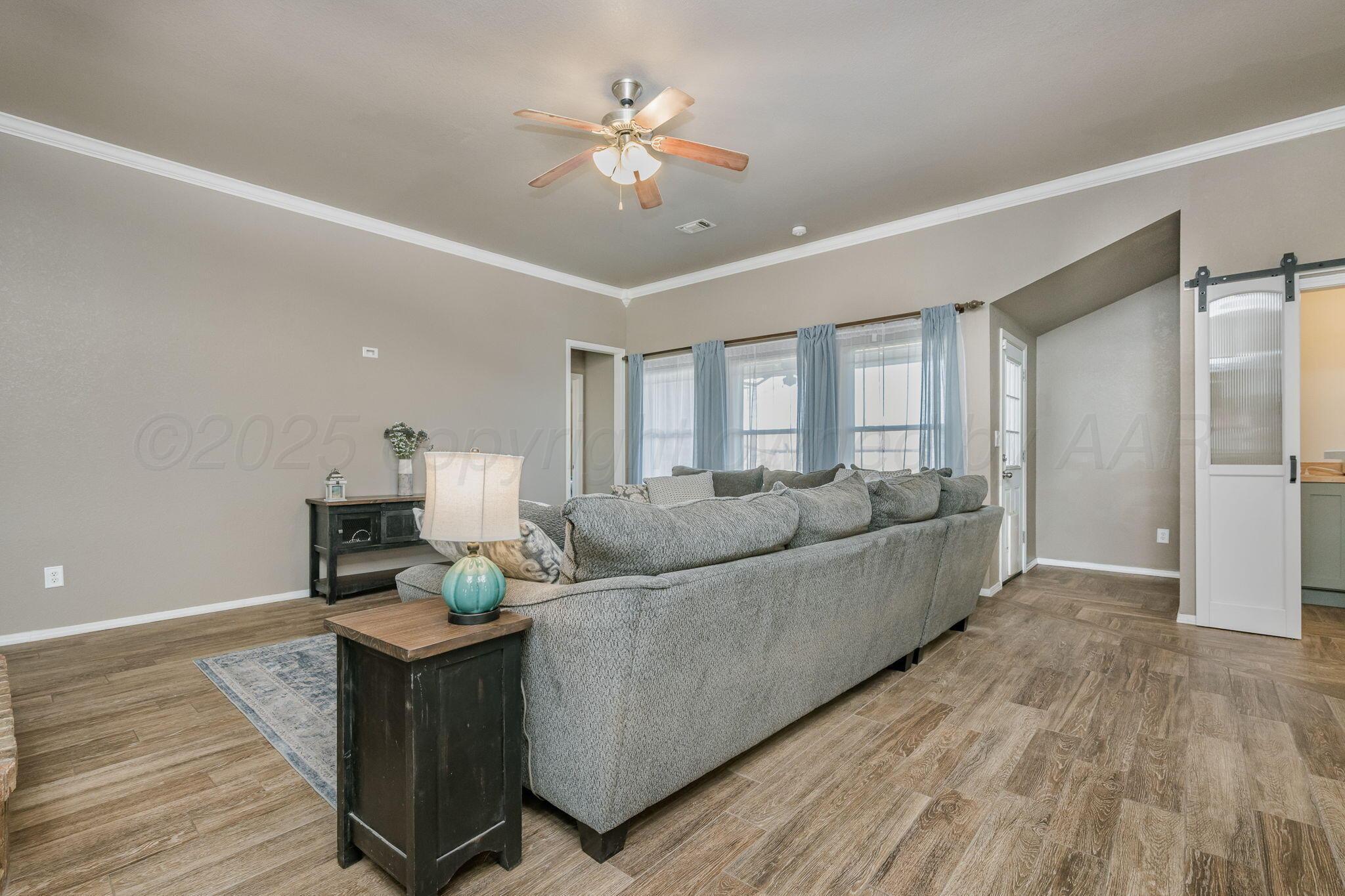 1404 Southwest 61st Avenue Amarillo, TX 79118 - Photo 8 of 30 a living room with furniture and a wooden floor