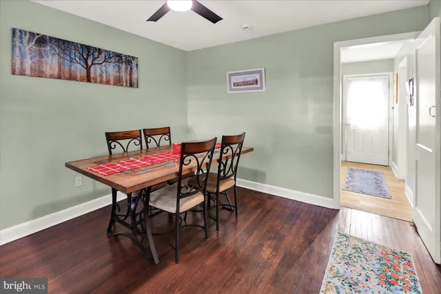 a view of a room with furniture and wooden floor
