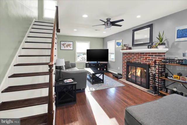 a living room with furniture a fireplace and a flat screen tv