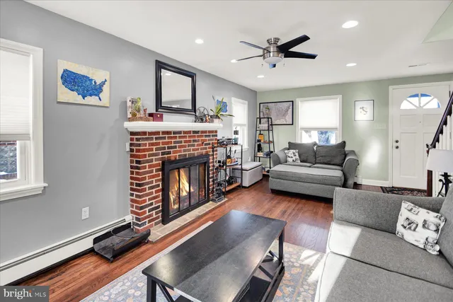 a living room with furniture fireplace and a window