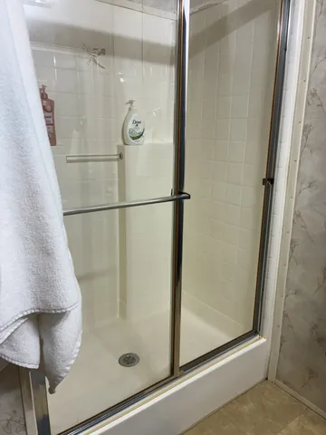 a bathroom with a glass shower door