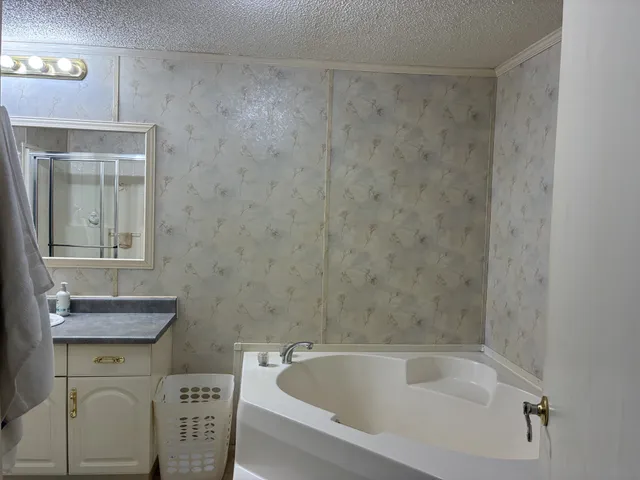 a bath tub sitting next to a white toilet