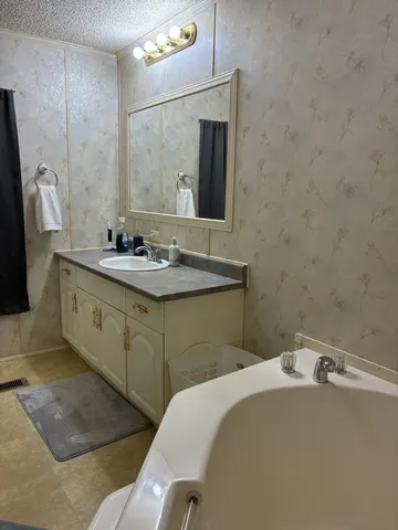 a bathroom with a sink and mirror