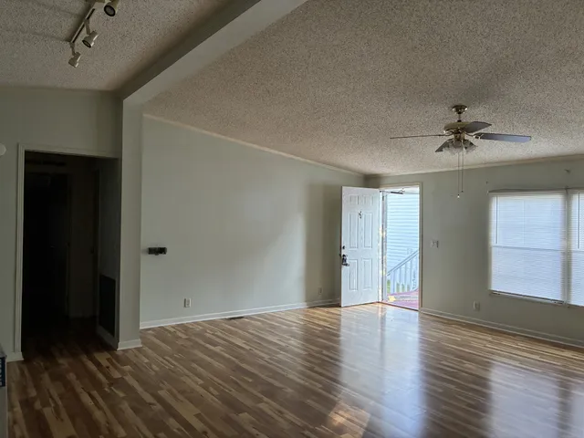 wooden floor in an empty room with a window