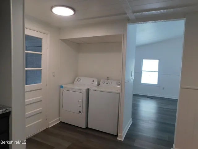 a utility room with cabinets washer and dryer