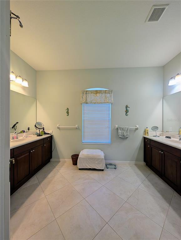 343 Marsh Creek Road Venice, FL 34292 - Photo 12 of 30 a spacious bathroom with a granite countertop sink a toilet and mirror