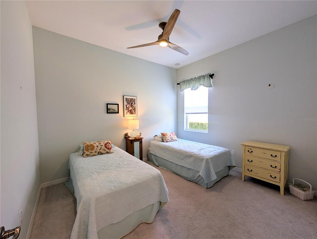 343 Marsh Creek Road Venice, FL 34292 - Photo 14 of 30 a bedroom with two beds and a window