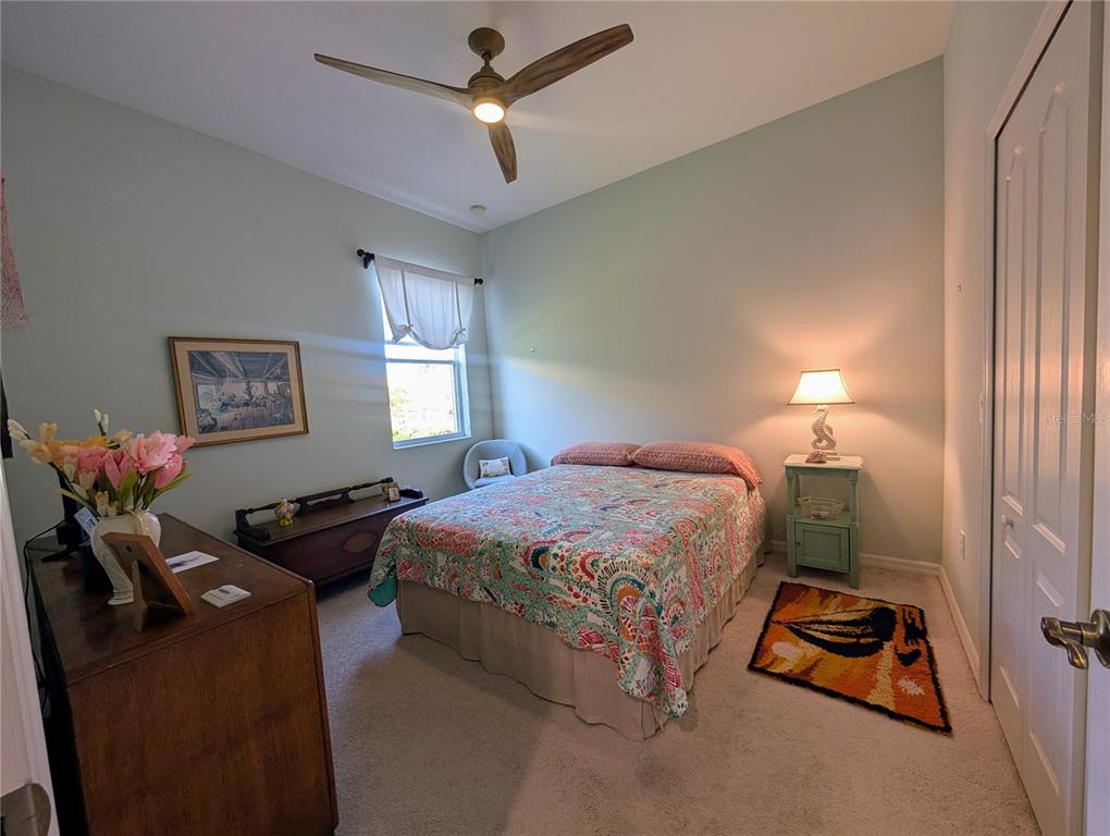 343 Marsh Creek Road Venice, FL 34292 - Photo 15 of 30 a bedroom with a bed and a chandelier