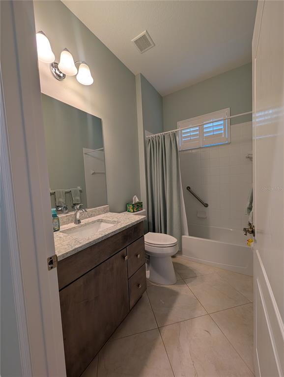 343 Marsh Creek Road Venice, FL 34292 - Photo 16 of 30 a bathroom with a sink a toilet and a mirror