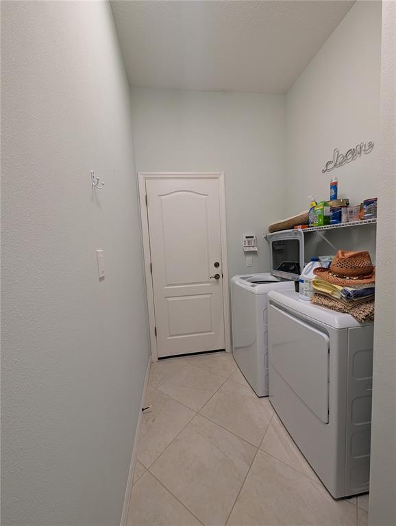 343 Marsh Creek Road Venice, FL 34292 - Photo 20 of 30 a utility room with cabinets washer and dryer