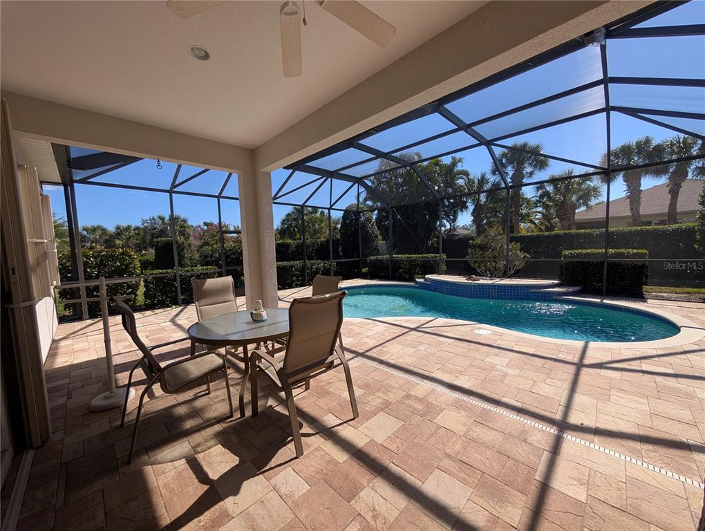 343 Marsh Creek Road Venice, FL 34292 - Photo 22 of 30 a view of a patio with a table and chairs under an umbrella