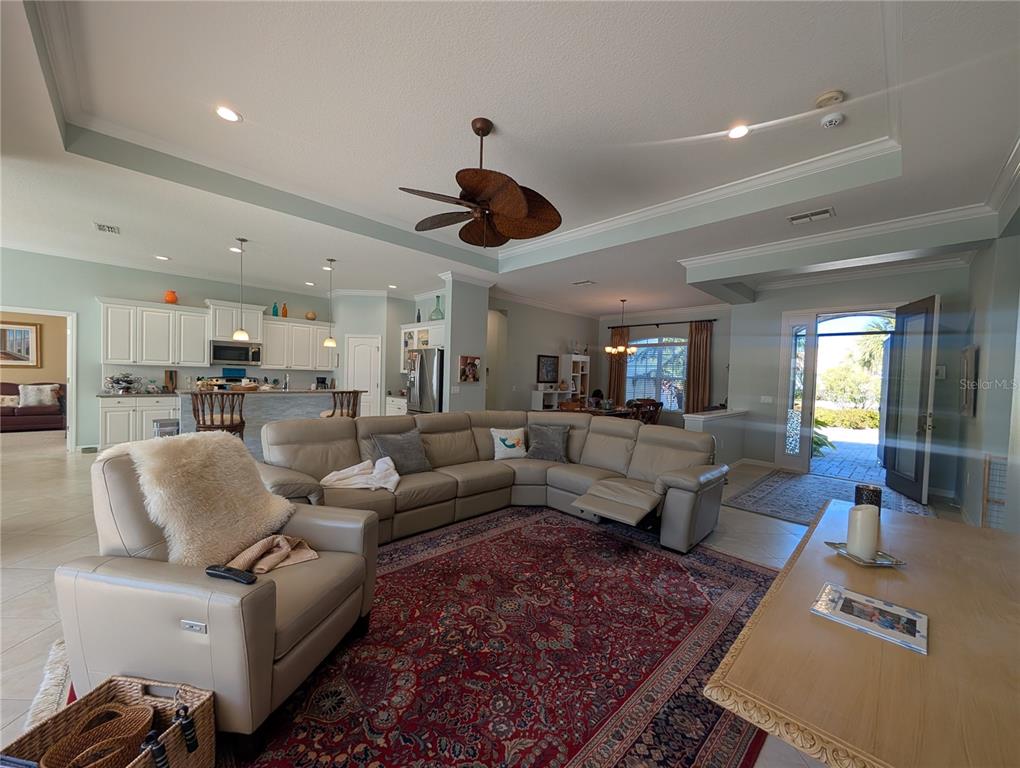 343 Marsh Creek Road Venice, FL 34292 - Photo 5 of 30 a living room with furniture kitchen view and a chandelier