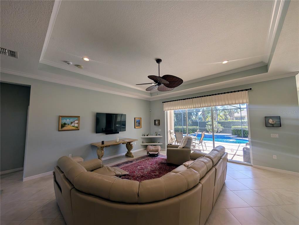 343 Marsh Creek Road Venice, FL 34292 - Photo 6 of 30 a living room with furniture and a flat screen tv