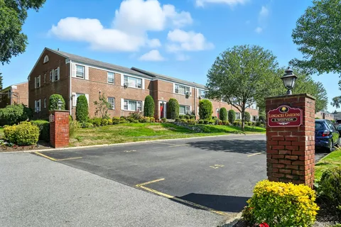 a front view of a building with garden